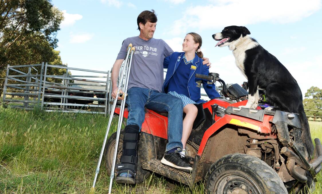 Dominic Hanrahan with his daughter Gemma, and cattle dog Cleo, at their property at Navigators. Picture: Kate Healy