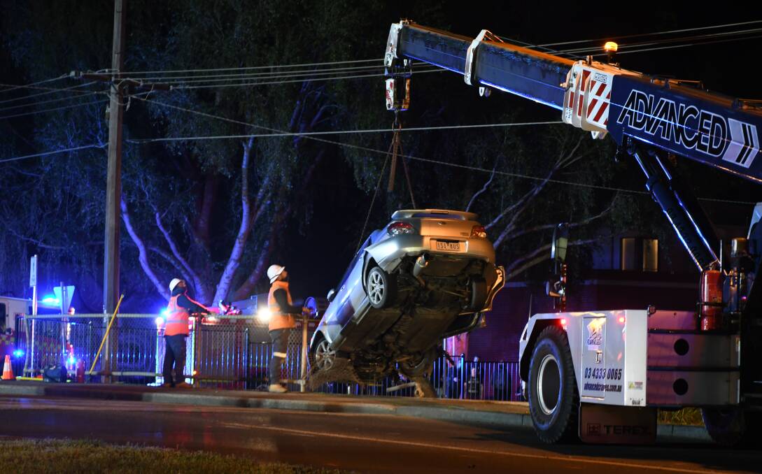 The car is removed from the bridge by crane