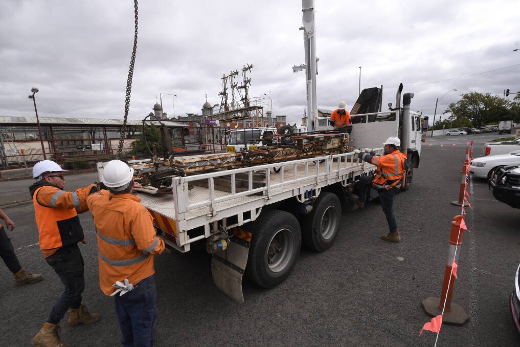 Refurbishment: Workers take down the heritage signals at the Ballarat train station. Picture: Lachlan Bence