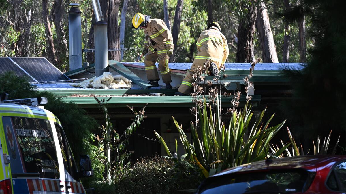 Firefighters on the roof of a Snake Valley house after a fire. Picture by Lachlan Bence
