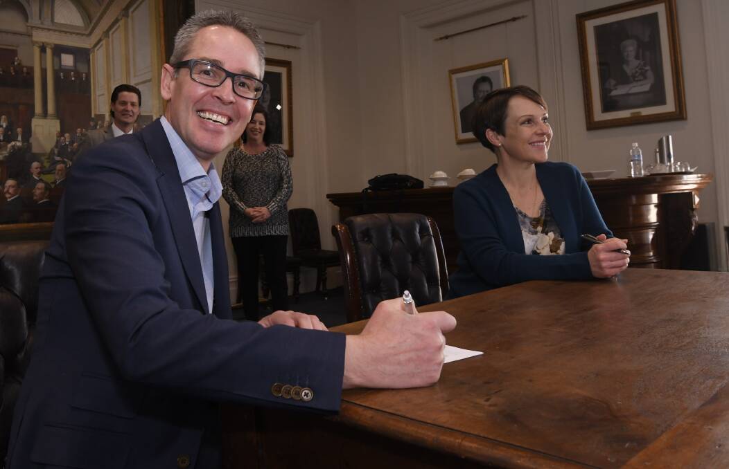 Signed up: City of Ballarat mayor Ben Taylor signs the Small Business Friendly Council Charter with state Minister for Small Business Jaala Pulford, with Small Business Ministerial Council chair Stuart Benjamin and Commerce Ballarat chief executive Jodie Gillett. Picture: Lachlan Bence