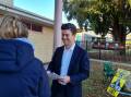 First time: Hawke's Labor candidate Sam Rae hands out flyers in Ballan on Saturday morning. Picture: The Courier
