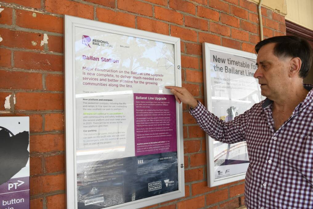 Mission accomplished: Nick Beale points out a V/Line poster at Ballan station which states major works are now complete.