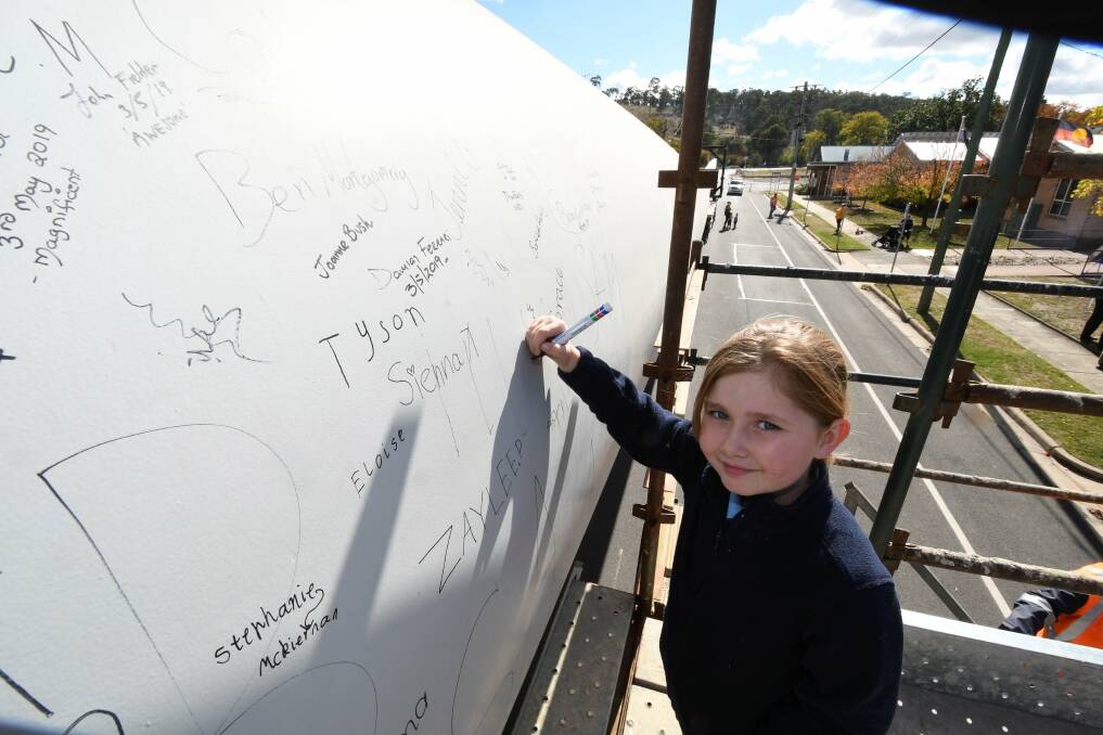 Signature: Seven-year-old Trawalla Primary School student Lylah puts her name on the blade.