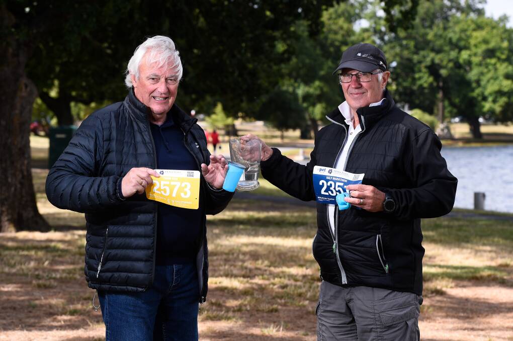Get ready, get set: Ballarat Regional Athletic Centre vice-president Rod Griffin and Cycle Classic committee member John Ives test out one of the new collapsible cups. Picture: Adam Trafford