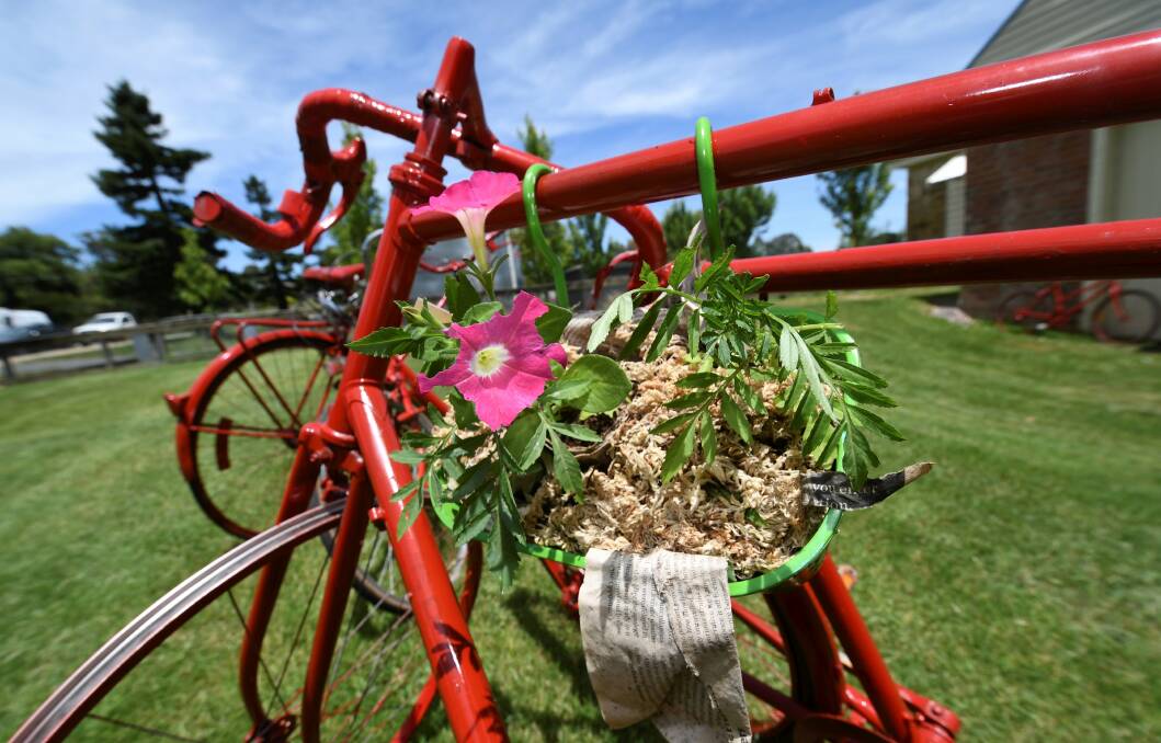 One of the flower boxes prepared by grade three students attached to a red bike.