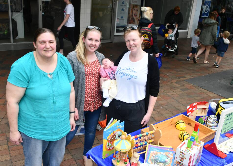 Toy library secretary Sylvia Stephens and volunteers Stephanie Freeman and Jessica Moore, with Adele, at the Children's Week Kids' Carnival. Pictures: Alex Ford