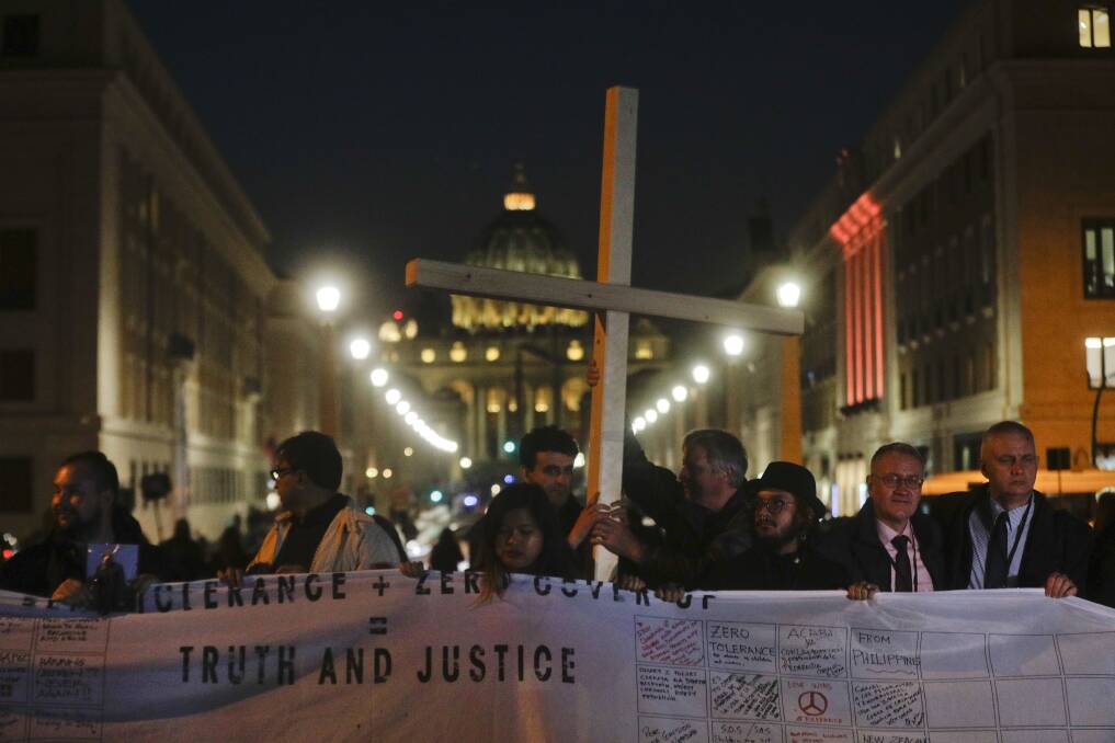 Righteous: Survivors of sex abuse on the road leading to St Peter's Square at a twilight vigil in Rome on Thursday. Picture: AP Photo/Gregorio Borgia