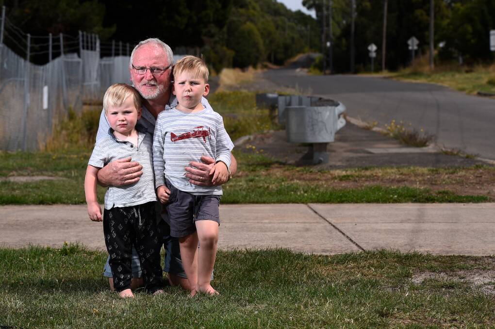 Larter Street resident Jeff Hardy, with grandsons Oliver and Thomas, is petitioning for speed humps to slow hoon drivers. Picture: Adam Trafford