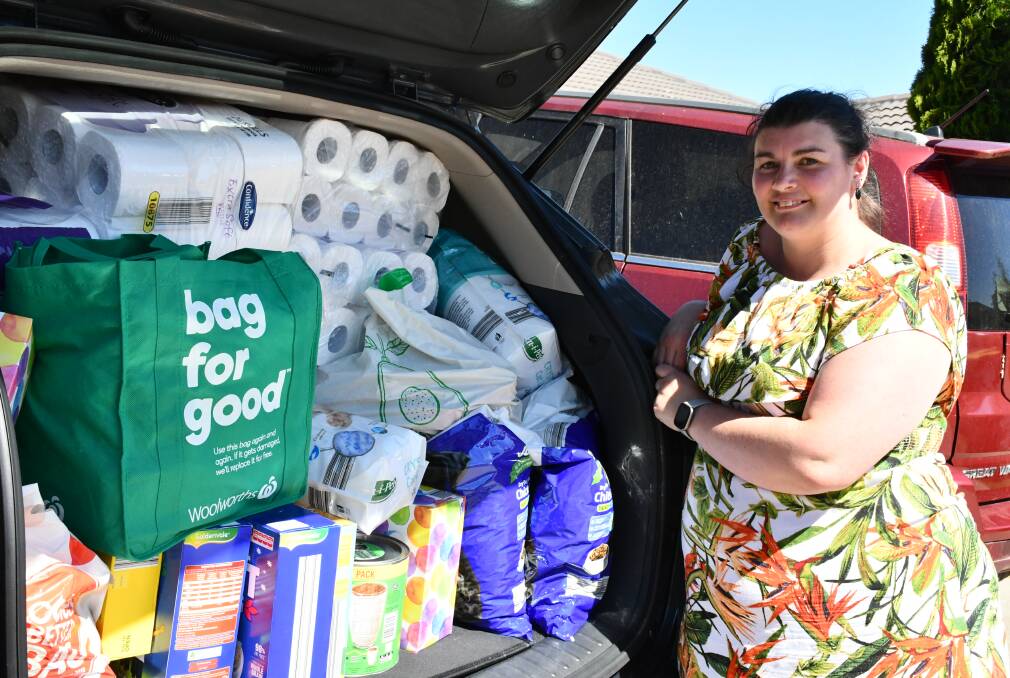 Help is on its way: Robyn Power with a car-load of donated items.