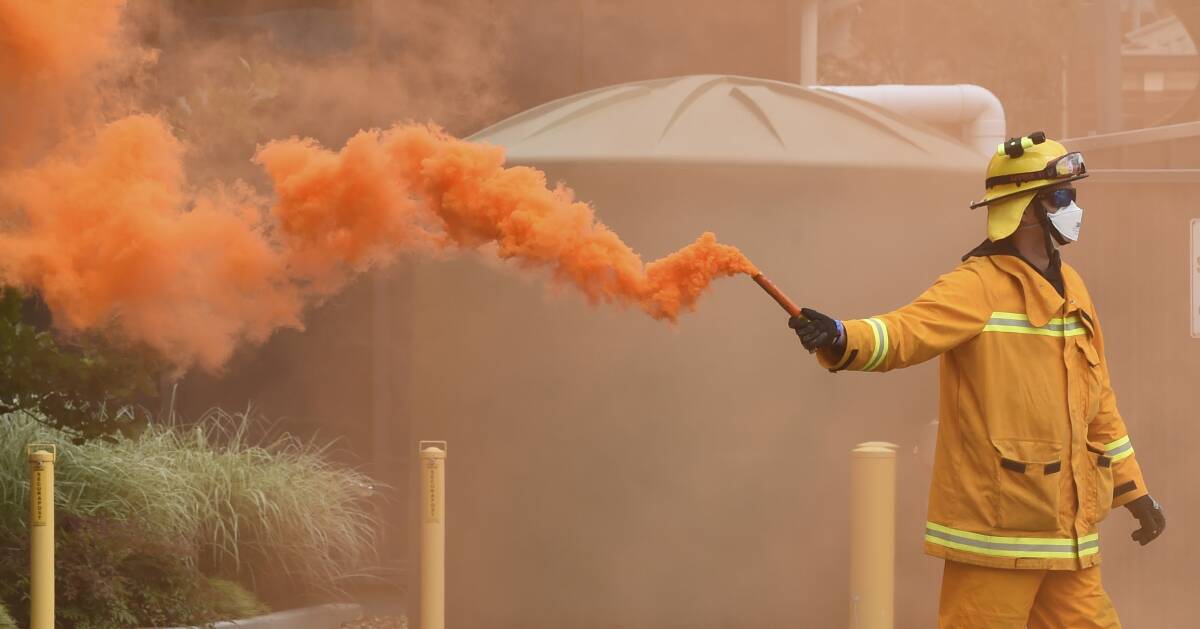 A firefighter with a flare at the exercise.