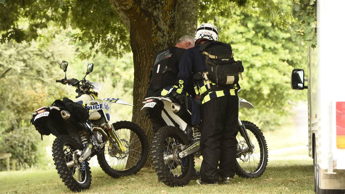 Officers on dirt bikes check a map in Buninyong before continuing the search. Picture by Adam Trafford