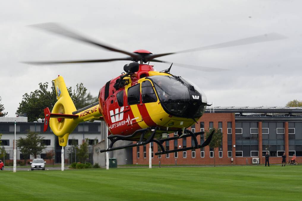 Coming in hot: The Westpac Rescue helicopter, a Microflite Airbus EC135, lands at St Patrick's College on Friday afternoon. Picture: Kate Healy