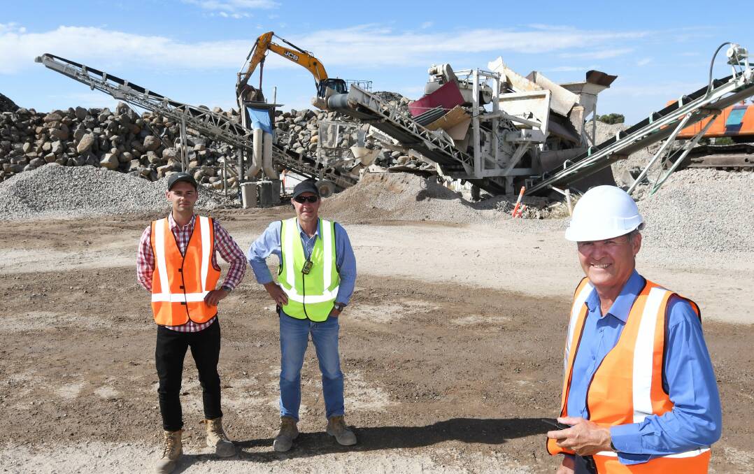 On the grind: Garden Recycling Centre manager Peter Kuzmich with Joshua and Eric Kuzmich, in front of the concrete grinder they developed. Picture: Lachlan Bence