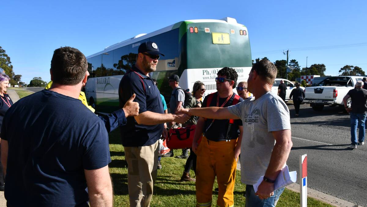 Strike team leader Roger Perris (right) farewells and thanks firefighters in Ballarat.