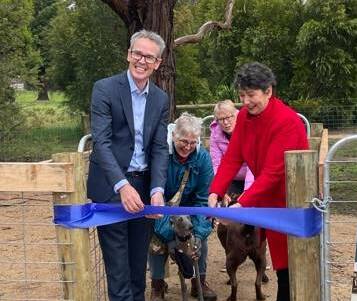 Cr Ben Taylor and Buninyong MP Michaela Settle cut the ribbon at the new James Reserve dog park before some residents jump in. Picture: contributed
