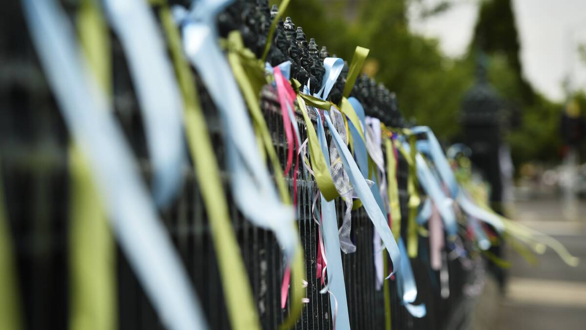 Reminders: Ribbons on the fence outside St Patrick's Cathedral. Picture: Dylan Burns