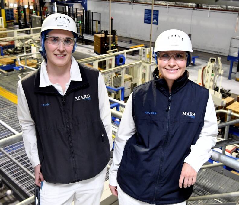 Represent: Mars electrical controls engineer Leah Portlen and value stream manager Heather Lord in the wrapping room. Picture: Lachlan Bence