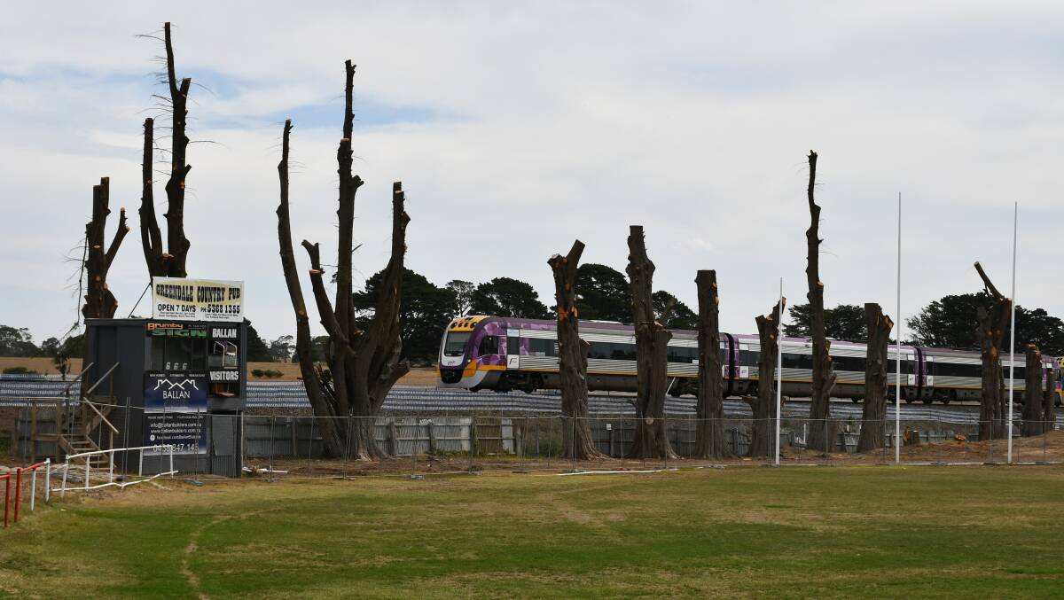A V/Line train goes past the Ballan Recreation Reserve.