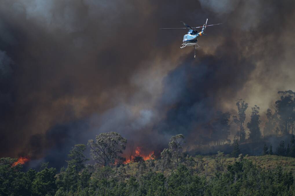 A waterbombing helicopter heads to the April Mount Clear fire. Picture: Kate Healy