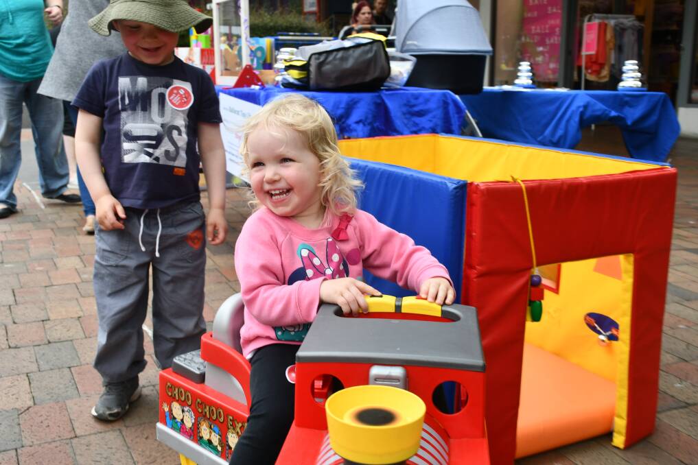 Abby Burnett takes a ride on one of the toy library's larger items at the Kids' Carnival.