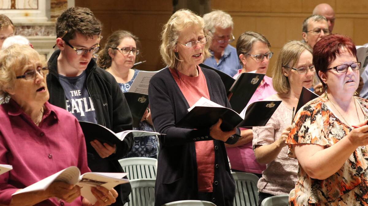 The Carols in the Cathedral chorus rehearsing this week. Picture: supplied.