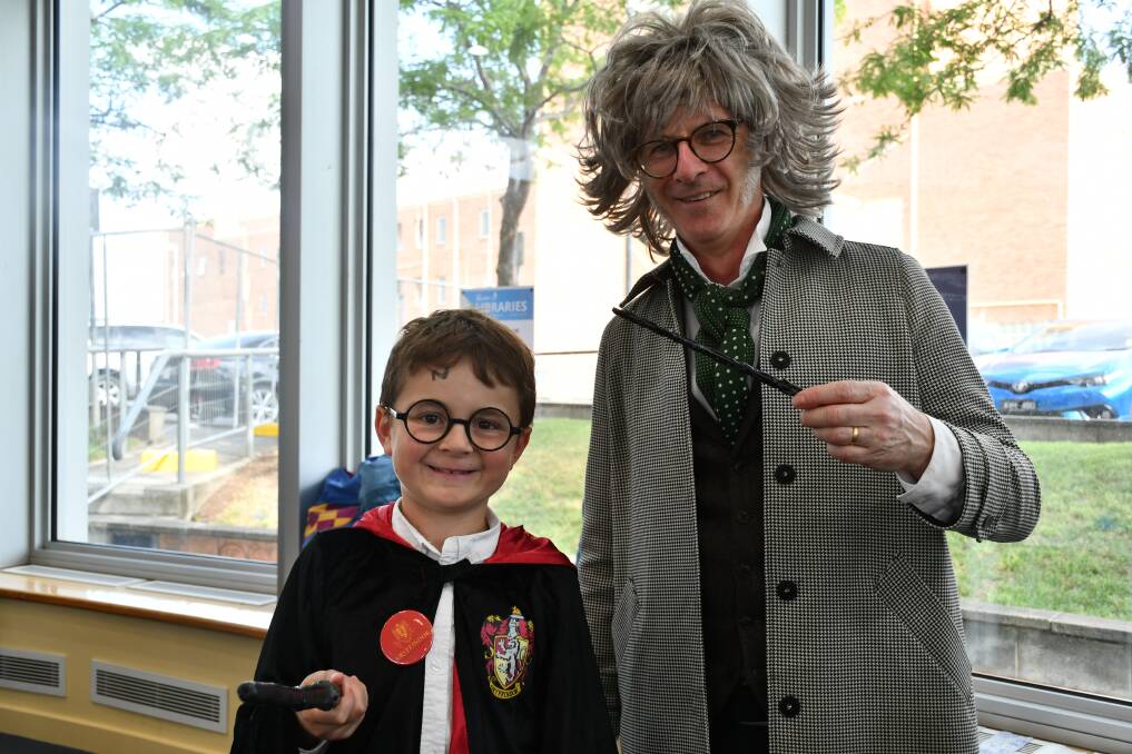 The wand chooses the wizard: Thomas Hancock, 8, selects a wand with Mark MacNamara at Ballarat Library's Harry Potter Book Night.