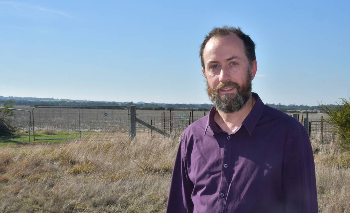 Geoff Adams at the edge of the Golden Plains Wind Farm project - look closely and you can see Mt Mercer's wind farm in the distance.