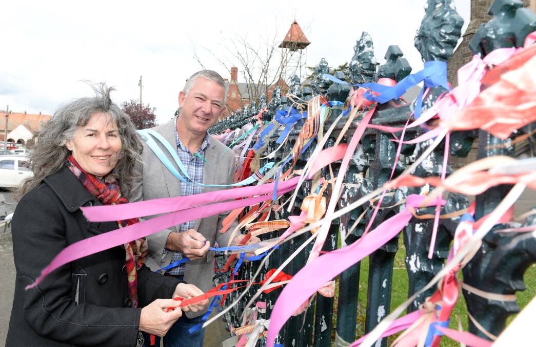 Hope: Advocate Chrissie Foster with former detective Peter Fox tying ribbons on the St Patrick's Cathedral fence in recognition of victims and survivors of clerical sexual abuse. Picture: Kate Healy