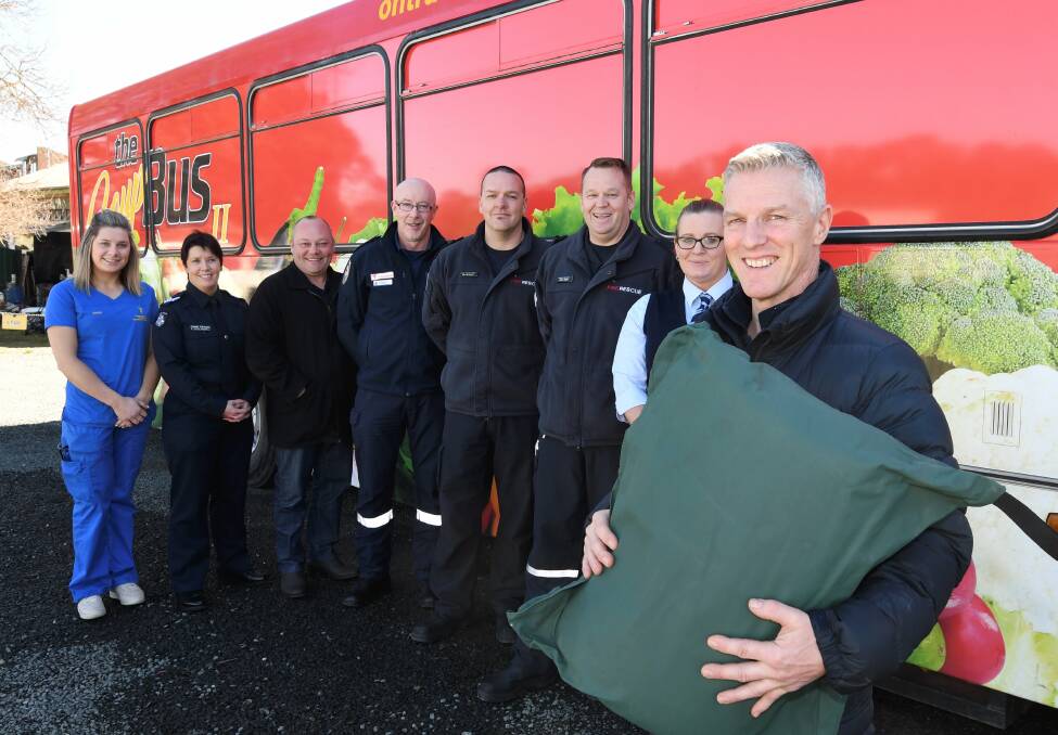 All smiles: Emergency service workers Madeline Gell, Lynette O'Donohue, Anthony Stephens, Tim Maywald, Ben Reynolds, Jason Adams, Briannon Gibson, and Soup Bus founder Craig Schepis. Pictures: Lachlan Bence