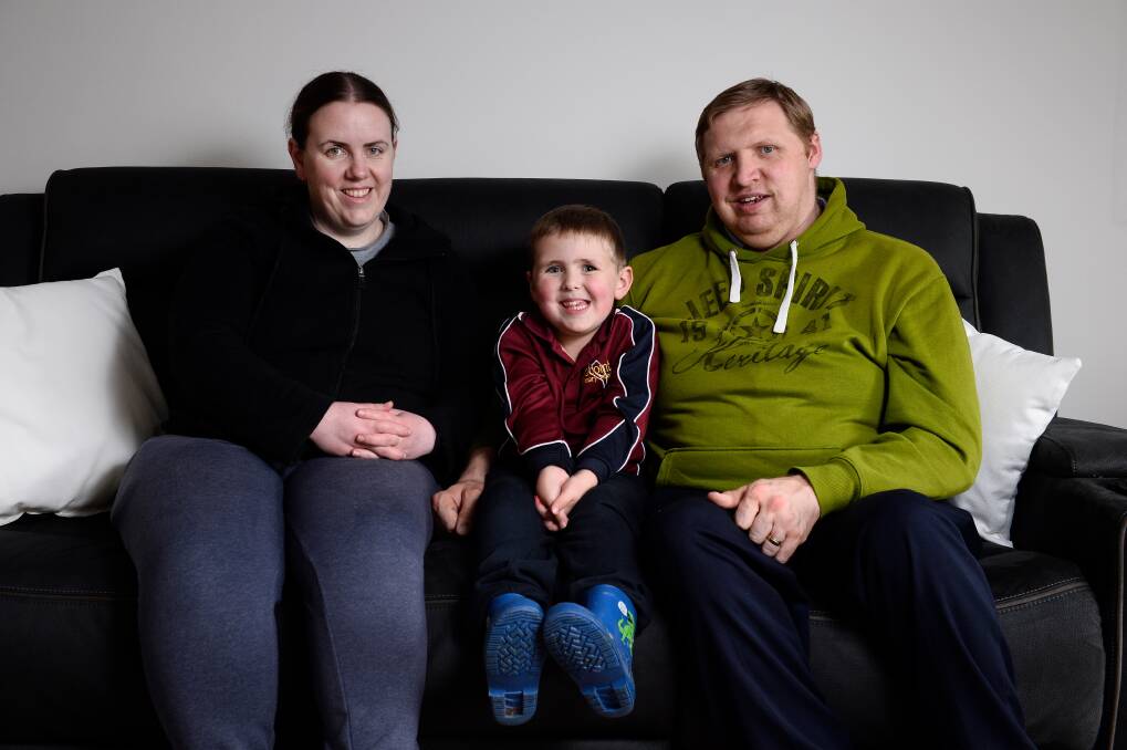 FAMILY: Ollie with his parents Lauren and Brock Powell. Picture: Adam Trafford
