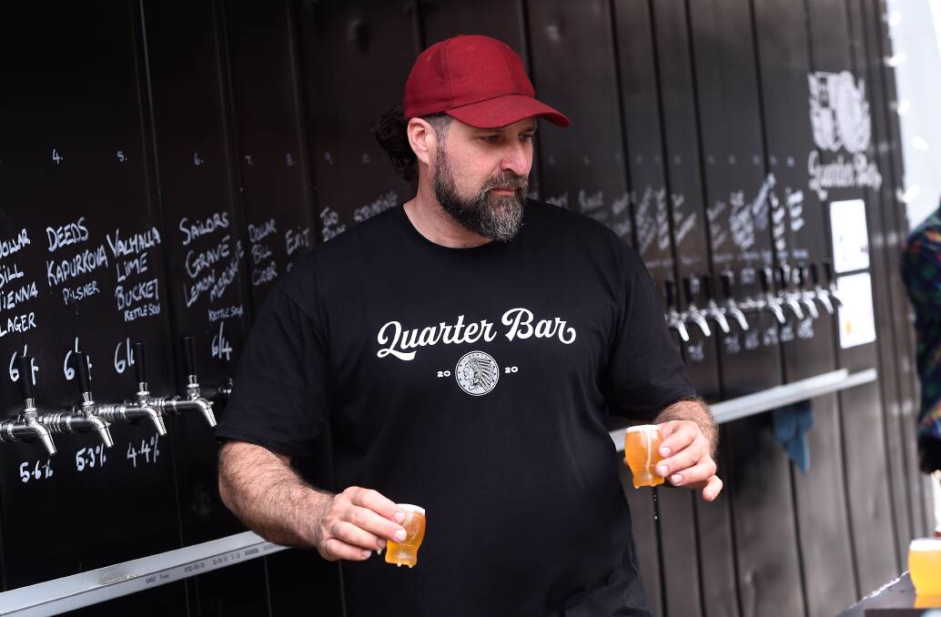 Ed Nolle pours paddle samplers at Quarterbar. Picture: Adam Trafford