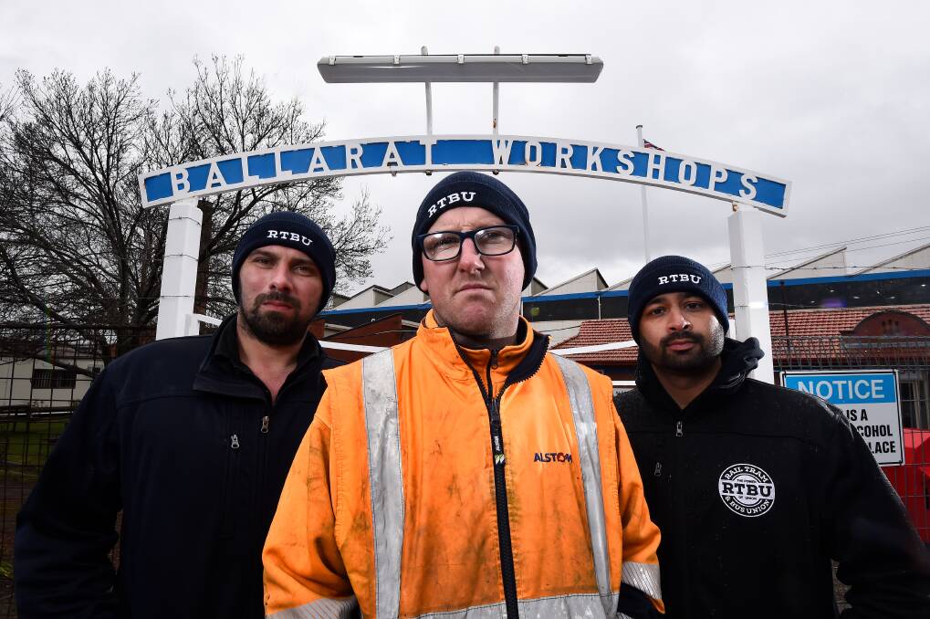 Alstom's Luke Cornish (centre) with Bryan Evans and Vic Sharma from the Rail, Tram, and Bus Union in front of the Alstom Ballarat workshops gate. Pictures: Adam Trafford