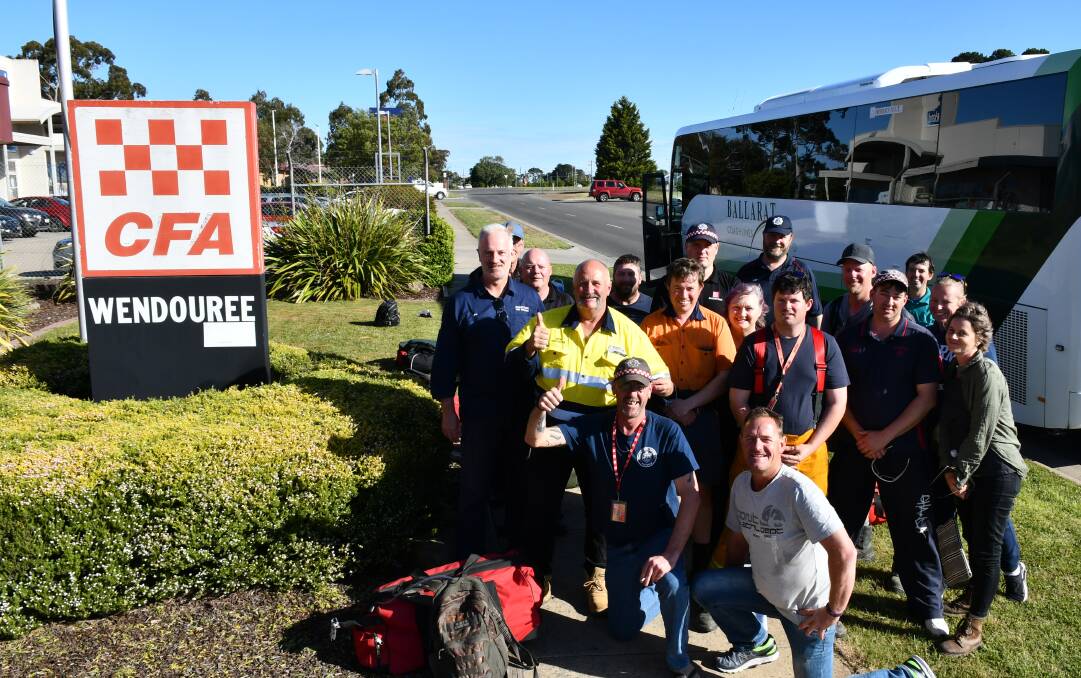 Back home: Members of the CFA District 15 and 16 strike team on home soil after fighting fires in New South Wales for the past week.