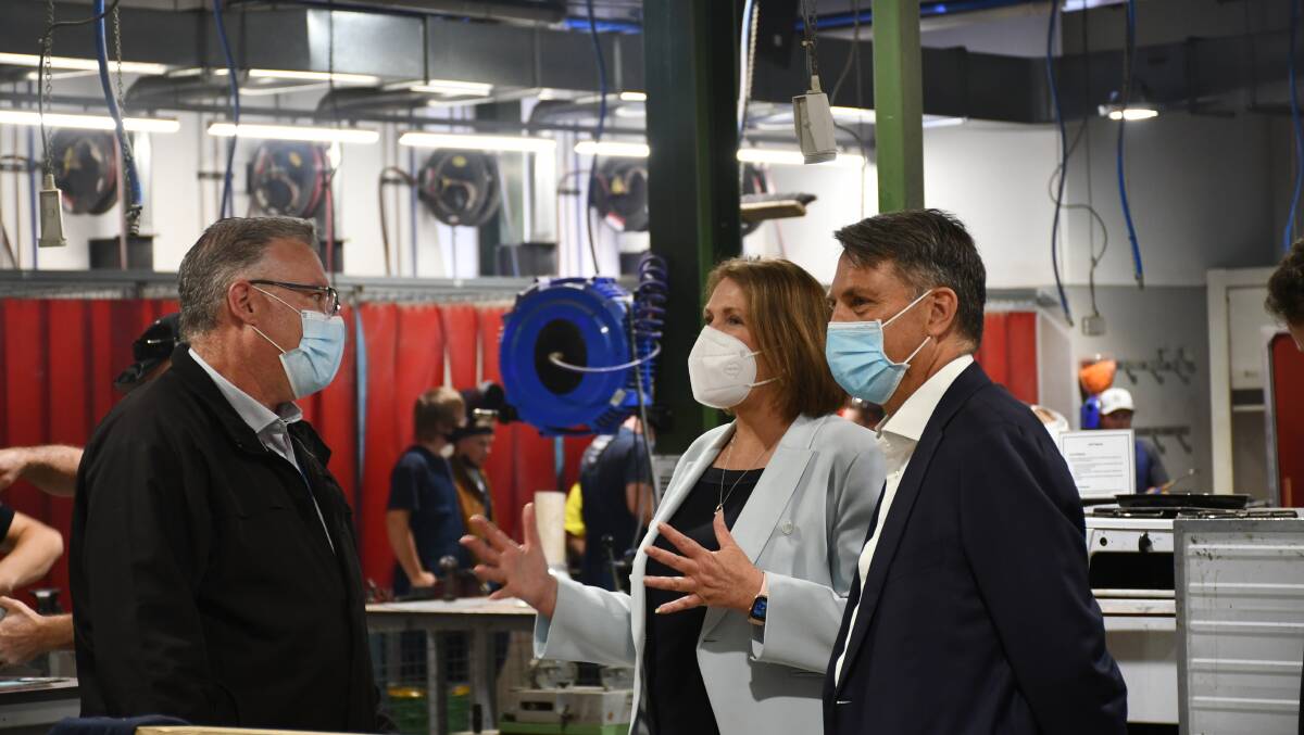 Promises: Federation TAFE staff show Ballarat MP Catherine King and deputy opposition leader Richard Marles around a workshop. Picture: The Courier