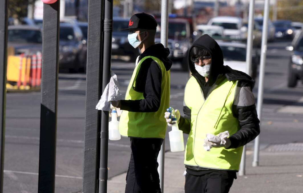 Scrubbed: Workers hit Sturt Street to disinfect street furniture. Pictures: Lachlan Bence