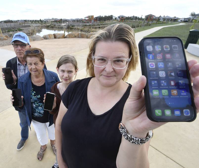 Fix it: Leah Heinrich, with neighbours Peter and Judy Skinner and daughter Tilley Ramsey, is fed up with the lack of mobile phone coverage in Lucas. Picture: Lachlan Bence