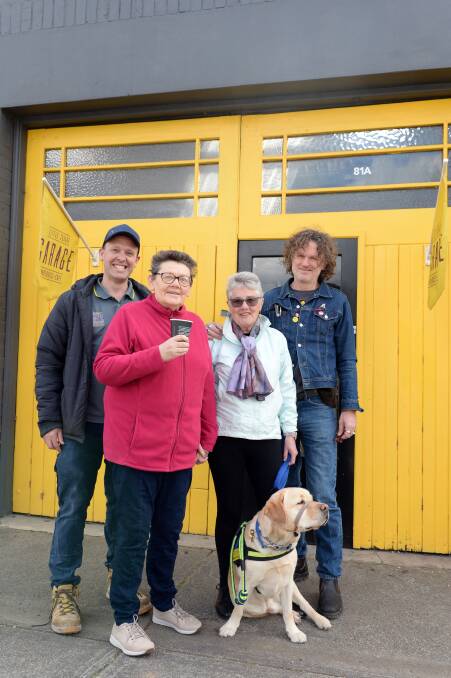 Stephen Tudor, Edie Mayhew, Anne Tudor with Melvin, the service dog, and Andy Ferguson at Little Square Garage. Picture: Kate Healy