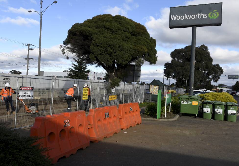 Workers near one of the Albert Street exits from the car park. Picture: Lachlan Bence