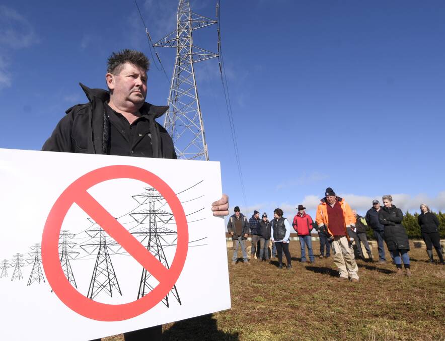 Dean farmer Andrew Maher beneath the 220 kilovolt line on his property with other farmers from the area. Picture: Lachlan Bence