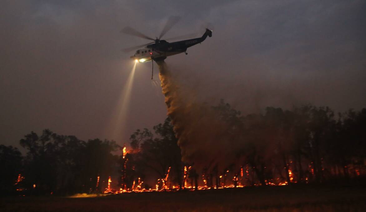 Bombs away: Helitak 322 conducts waterbombing operations on Friday night near Rosedale. Picture: Andrew Norman, Traralgon West Fire Brigade