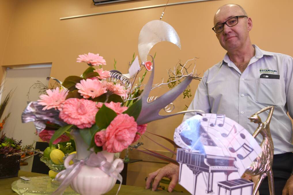 Floral art: City of Ballarat Curator Parks and Nursery Peter Marquand at the Ballarat Floral Art Group's display. Picture: Lachlan Bence 