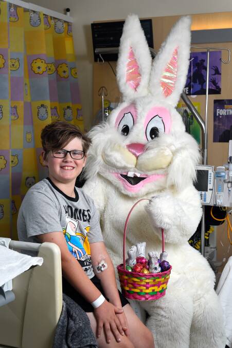 Eleven-year-old Jackson Templeton poses for a photo with the Easter Bunny during a Lions Club Ballarat visit to Ballarat Health Services. Picture: Adam Trafford