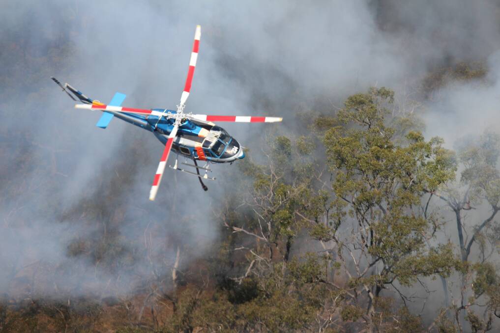Flight force: The helitack was called in by ground crews as the fire edged on to thick and difficult to access scrub.