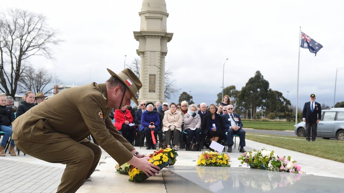 Reflection: Warrant Officer Class 2 Gary Kirk lays a wreath next to the statue of the grieving mother next to the Arch of Victory. Picture: Kate Healy