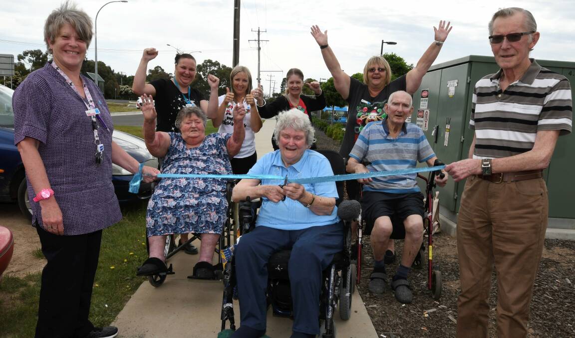 Freedom: Margaret Griffiths and her fellow BUPA Aged Care residents and carers cut the tape on a new footpath linking to the Delacombe Town Centre. Picture: Lachlan Bence