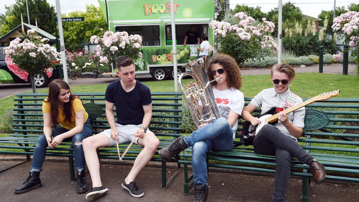 Warm up: Members of Butterfunked Anna Wright, Nick Withers and Bevan Kelly with musician Rhiannon Simpson at the Ballarat Botanical Gardens. Picture: Kate Healy