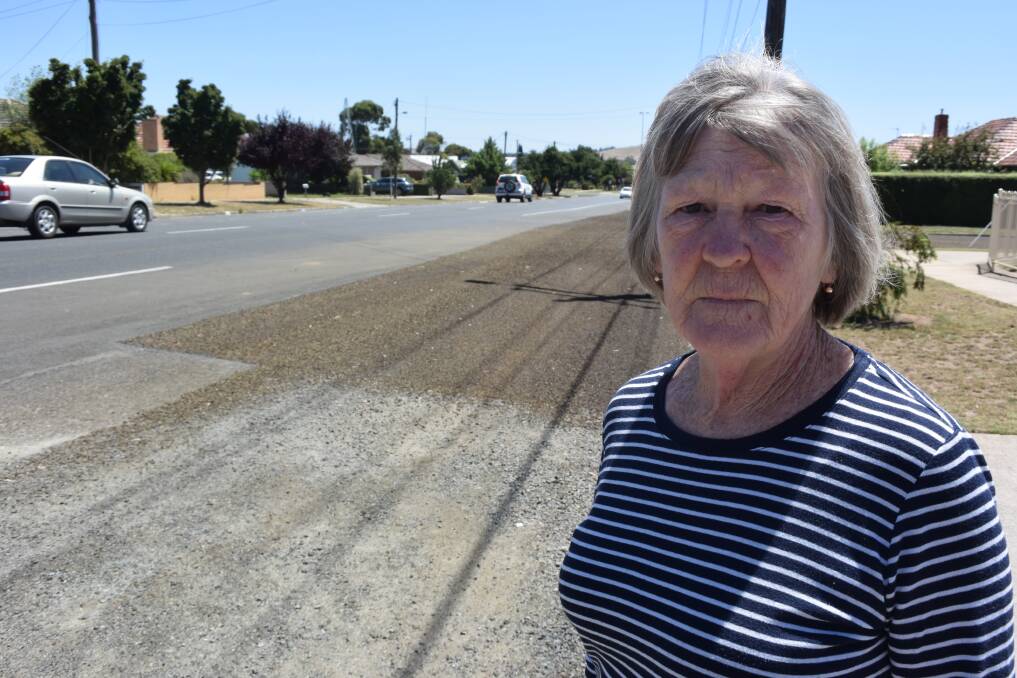 Rocky road: Forest Street resident Carol Taylor was shocked when council workers told her 20 metres of gravel out the front of her home would not be sealed, despite recent bitumen works to the left and right of the patch.