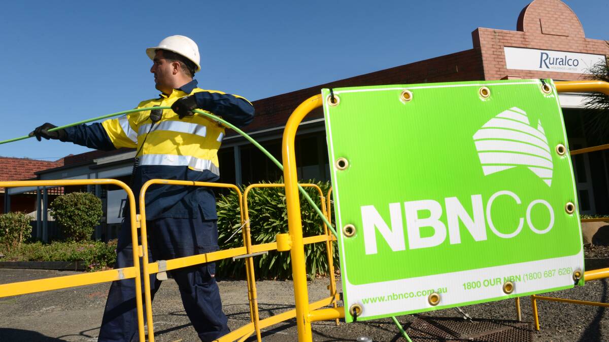 An NBN Co worker installs a cable. Picture: Adam Trafford