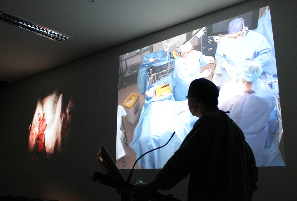 Stitch in time: Queenland colorectal surgeon Dr John Lumley watches as a live, narrated procedure occurs in the Ballarat Base Hospital on Friday.
